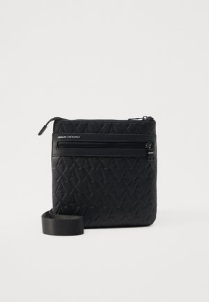Black nylon crossbody bag with embossed logo, zippered pocket, and adjustable strap. Features a textured surface and minimalist design.