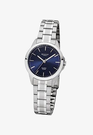 Montre-bracelet en métal argenté avec un cadran bleu, des marqueurs d'heure minimalistes et trois aiguilles indiquant 10:09:38.