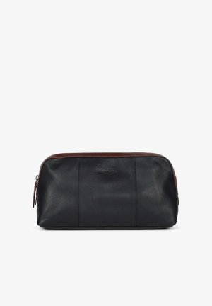 Læder toilettaske med en mørk navy krop og en brun detalje. Har en lynlåslukning og struktureret overflade. Logo prentet på forsiden.