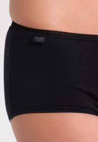 Black hipster underwear made of soft fabric, featuring a smooth waistband with lace trim and a small brand label on the side.