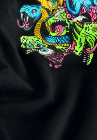 Black fabric featuring a colorful, detailed graphic of various snakes and monstrous faces in blue, green, yellow, and pink.