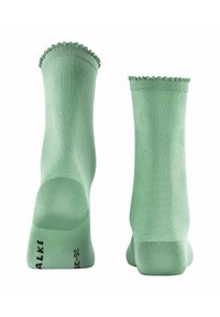 Chaussettes en coton vert avec un motif à pois en relief et un bord supérieur festonné. Taille marquée 35-38 sous le pied.