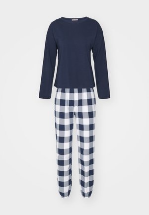 Navy long-sleeve top paired with white and navy checkered pajama pants featuring an elastic waistband and tapered cuffs.