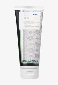 Tubetto di latte per il corpo al tè alla menta, 200 mL; bianco con accenti verdi e grigi, presenta un motivo a pizzo testurizzato, coperchio a flip-top e etichetta stampata.