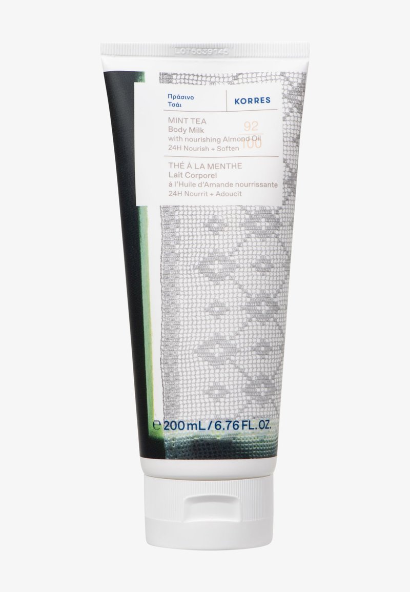 Tubetto di latte per il corpo al tè alla menta, 200 mL; bianco con accenti verdi e grigi, presenta un motivo a pizzo testurizzato, coperchio a flip-top e etichetta stampata.