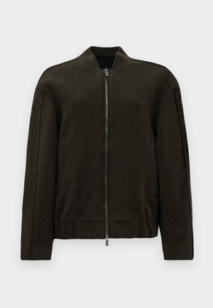 Dark green bomber jacket, made of textured fabric, features a zip closure, high collar, and side pockets with minimalistic design.
