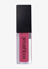 Couleur à lèvres liquide Smashbox en rose, présentée dans un conteneur rectangulaire transparent avec un capuchon carré noir et une inscription en gras sur le devant.