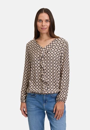 Blusa a maniche lunghe con scollatura a V, caratterizzata da un motivo testurizzato di piccoli diamanti chiari su sfondo scuro e un dettaglio frontale arricciato.