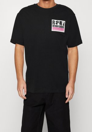 Black cotton T-shirt with a round neckline, short sleeves, and a front graphic logo in white and pink. Simple design, relaxed fit.