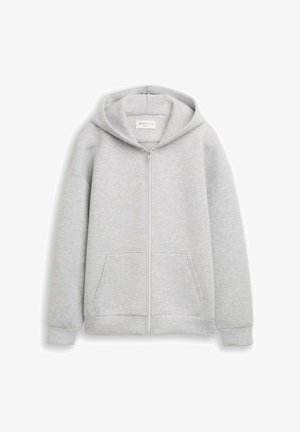Grijze rits-hoodie van zacht materiaal, met een voorrits, twee voorkzakken en een capuchon met trekkoord. Soepele textuur met geribbelde manchetten.