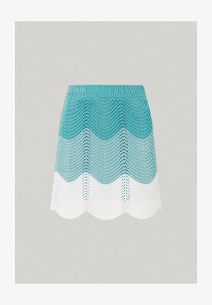 Strikket mini nederdel med et turkist og hvidt zigzag-mønster, med en bølget kant og struktureret garn. Let og åndbart materiale.