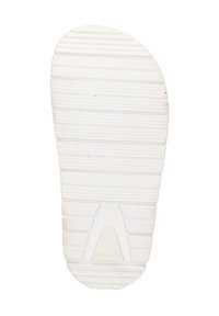 White rubber shoe sole with horizontal and vertical grooves, featuring a triangular indentation at the center and a smooth rounded tip.