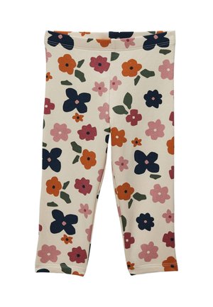 Leggings à motif floral en tissu crème présentant diverses fleurs en rose, orange et marine, avec des feuilles vertes et une ceinture simple.