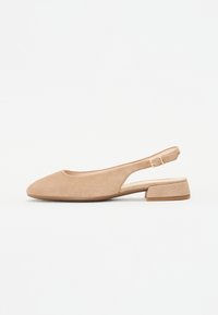 Slingback shoe in soft beige suede with a rounded toe and low block heel. Features an adjustable strap and a minimalistic design.