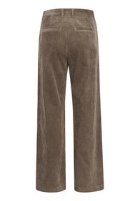 Ruskeat samettiset leveälahkeiset housut, joissa on pehmeä kulutus, kaksi takataskua ja pystyribbelikuvio. Sopii rentoon pukeutumiseen.