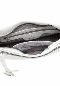 Vit läderväska med axelrem och ett huvudfack med dragkedja. Insidan har grå tygfoder med text och en mindre dragkedjeficka.