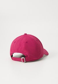 Pink baseball cap featuring a curved brim, adjustable strap at the back, and six ventilation holes for breathability.