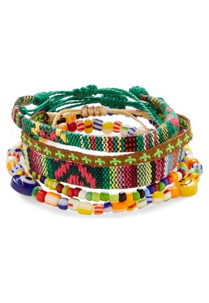Colorful stack of woven friendship bracelets and multicolored beaded bracelets with various patterns and smiley face beads.