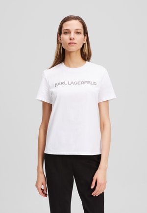 Weißes Baumwoll-T-Shirt mit Rundhalsausschnitt und kurzen Ärmeln, mit dem Aufdruck "KARL LAGERFELD" in silberner Schrift über der Brust.