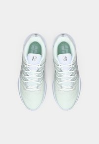 Light green athletic shoes with a textured mesh upper, white laces, and a padded collar. Features a logo on the tongue and a cushioned sole.