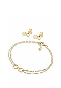 Gold jewelry set including two infinity-shaped earrings and a matching bracelet with a clasp, featuring delicate chain links and polished finish.