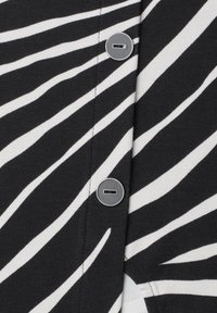 Black and white diagonal striped fabric with two round black buttons fastened vertically in the center.