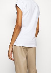 Cream T-shirt med print - white