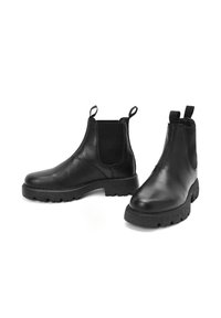 Stivali Chelsea in pelle nera con pannelli laterali elasticizzati, linguette per il pull e suole in gomma testurizzata, caratterizzati da una finitura liscia e punte arrotondate.