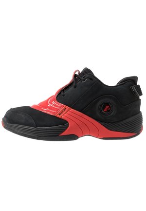 Schwarzer und roter Sportschuh mit niedrigem Profil, Mesh-Zunge, Schnürsenkeln und einer abgerundeten Sohle mit strukturiertem Grip.