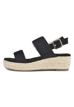 Schwarze Espadrille-Wedge-Sandale mit Stoffriemen, einer gewellten Korkplattform und einem geschnallten Knöchelriemen, ausgestattet mit einer flachen schwarzen Sohle.