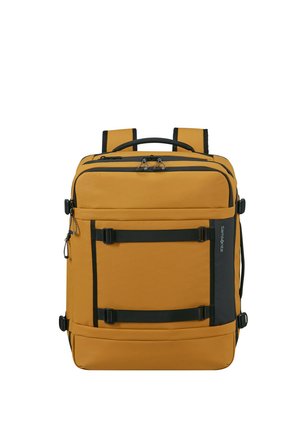 Rechteckiger Rucksack in Senfgelb mit schwarzen Trägern, mehreren Reißverschlussfächern und einem oberen Griff.