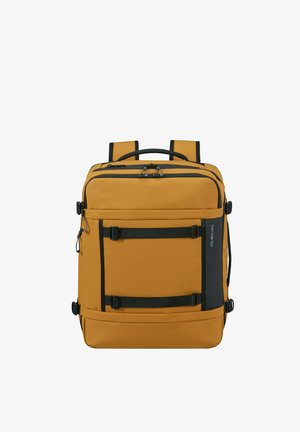 Mustard yellow rectangular backpack with black straps, multiple zippered compartments, and a top handle.