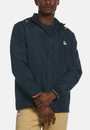Navy zip-up jacket made of lightweight fabric, featuring a hood, ribbed cuffs with white stripes, and a penguin logo on the chest.