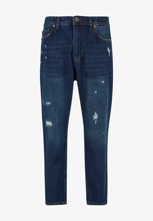 Dark blue denim jeans with a relaxed fit, featuring distressed patches and light fading, standard five-pocket design with copper hardware.