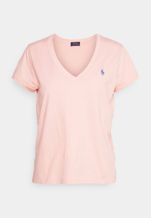 Polo t-skjorte i myk rosa, med v-hals og korte ermer. Inkluderer en liten blå brodert logo på venstre bryst.