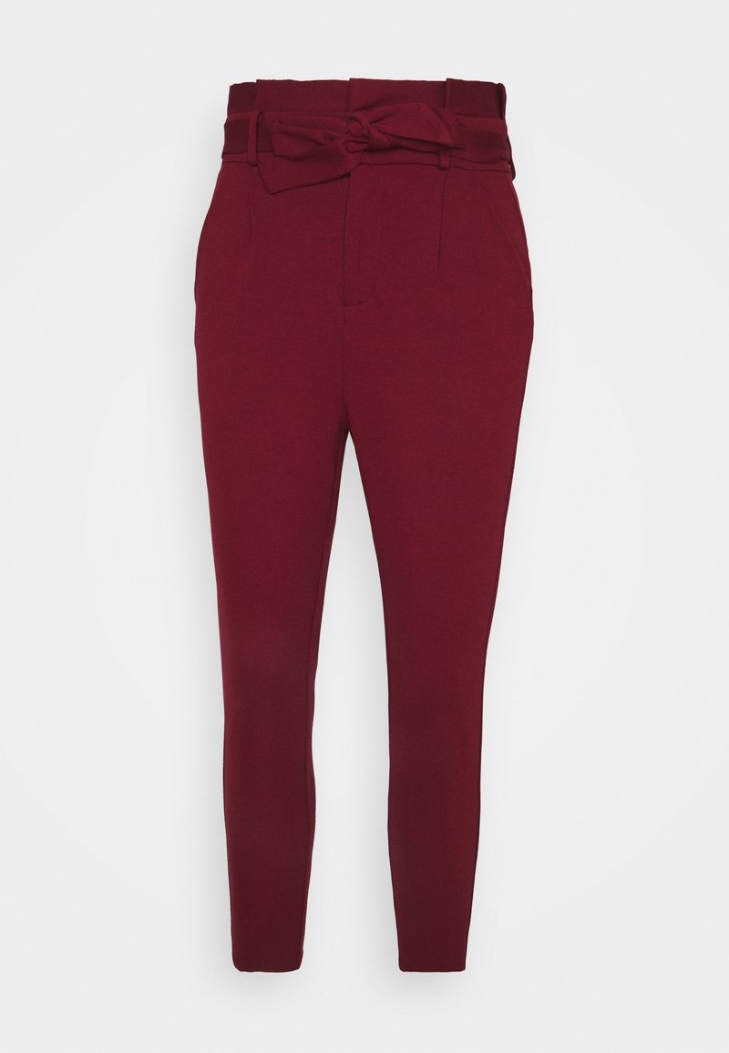Pantalon bordeaux taille haute, coupe fuselée avec taille paper bag et ceinture en tissu assorti nouée en nœud devant.