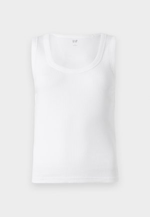 Bela rebrasta majica s širokimi naramnicami in okroglim izrezom. Narejena iz lahkega blaga. Ima preprost, brezokrasen dizajn.