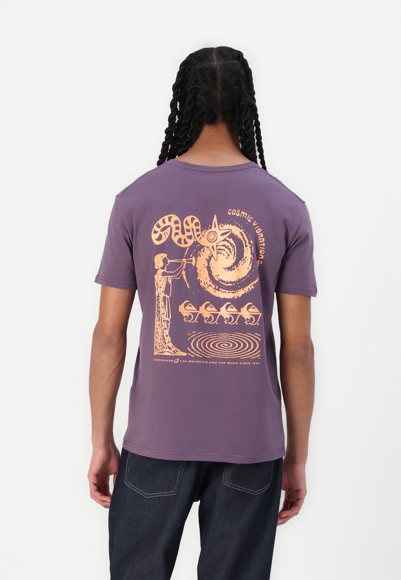 Short-sleeve purple cotton t-shirt featuring a large orange graphic design on the back, depicting abstract shapes and a figure playing an instrument.