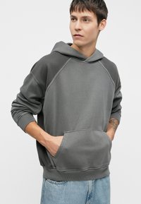 Gray hooded sweatshirt with a kangaroo pocket, raglan sleeves, and ribbed cuffs. Fabric has a soft texture with a relaxed fit.