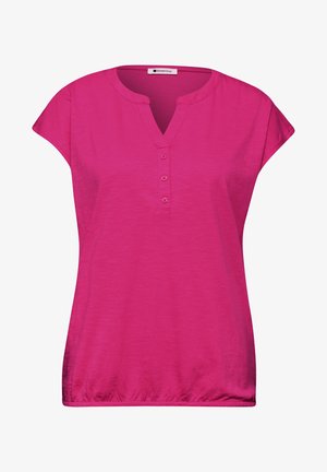 Blouse rose vif à manches courtes avec col en V, trois boutons sur le devant et ourlet élastiqué, marquée Street One.