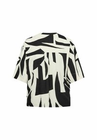 Korte mouwen top in een witte stof met een gedurfde zwarte abstracte print. Relaxe pasvorm met een split aan de achterkant.