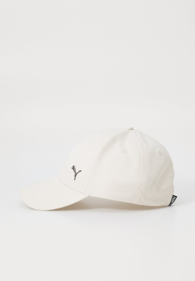 Casquette de baseball blanche avec une visière courbée et un logo brodé en gris métallique sur l'avant. Elle présente des trous de ventilation et une petite étiquette sur le côté.