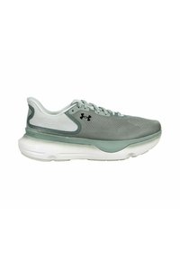 Scarpa sportiva grigio chiaro con tomaia in rete testurizzata, dettagli verdi e suola bianca. Presenta una intersuola ammortizzata e lacci rotondi.