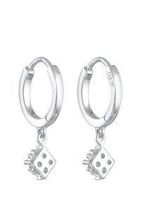 Silberne Creolen mit einem abnehmbaren Würfel-Anhänger mit schwarzen Punkten. Glatte Oberfläche, kreisförmige Form und polierte Metalltextur.