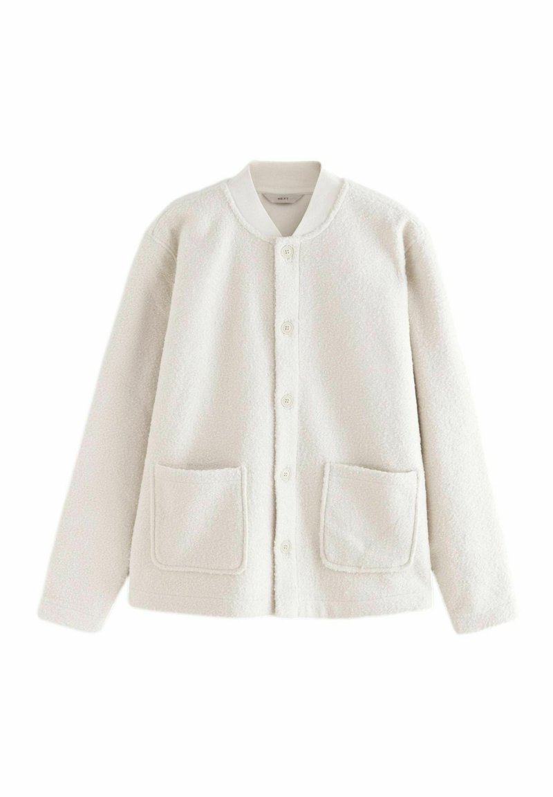 Cream-colored fleece jacket with a round collar, button front, two front pockets, and soft texture. Casual, relaxed fit.