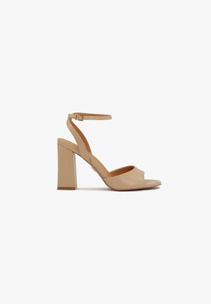 Beige leather heeled sandal with an open toe, ankle strap, and a wide block heel. Smooth texture with a natural finish.