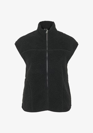 Mustast fliisist vest kõrge krae, ees tõmblukk ja ilma varrukateta. Omaduseks on tekstuurse pinnaga ja kontrastse õmblusega rinnal.