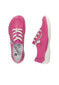Pink leather sneakers with white laces and a side zipper. Rounded toe, white sole, and a flower logo on the outer side. Smooth texture.