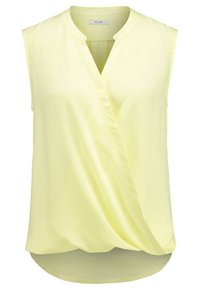 Sleeveless wrap blouse in light yellow. Features a V-neckline, smooth fabric, and a curved hem. Label reads "KIOMI."