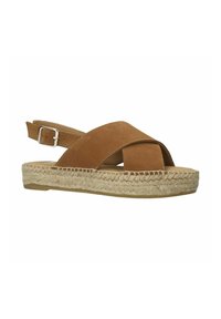 Sandales slingback en suede beige avec des brides croisées, semelle plateforme en jute, design à bout ouvert et boucle ajustable en argent.